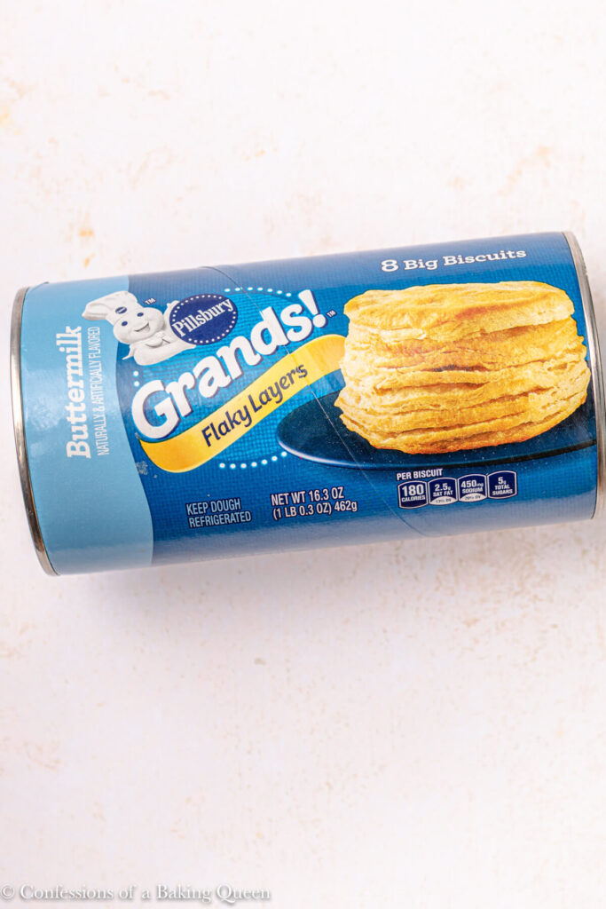 can of grands buttermilk biscuits  on a light pink surface