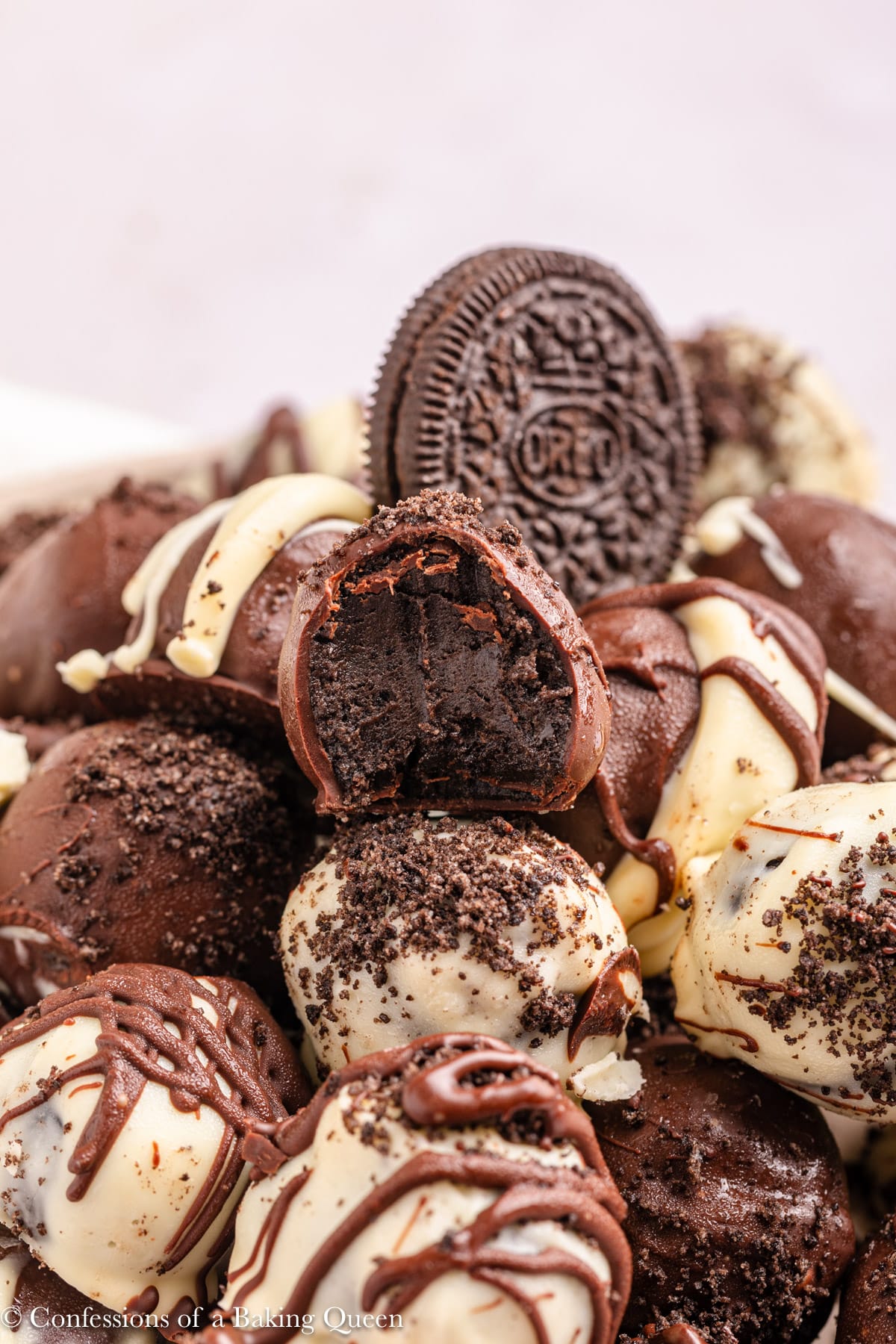 oreo truffle balls piled high with a half eaten on on top.