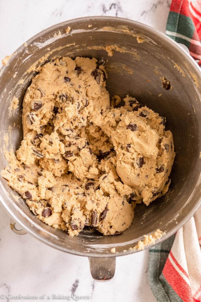 andes chocolate chip cookie dough in a metal bowl on a marble surface with a Christmas linen