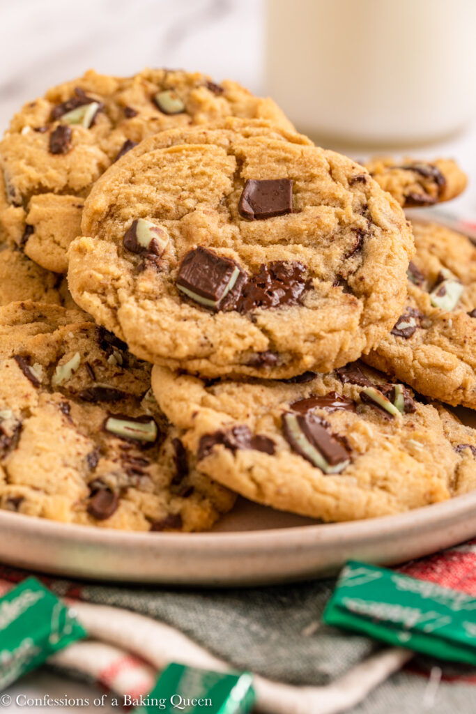 plate of andes chocolate chip cookies on top of a christmas linen on a white marble surface