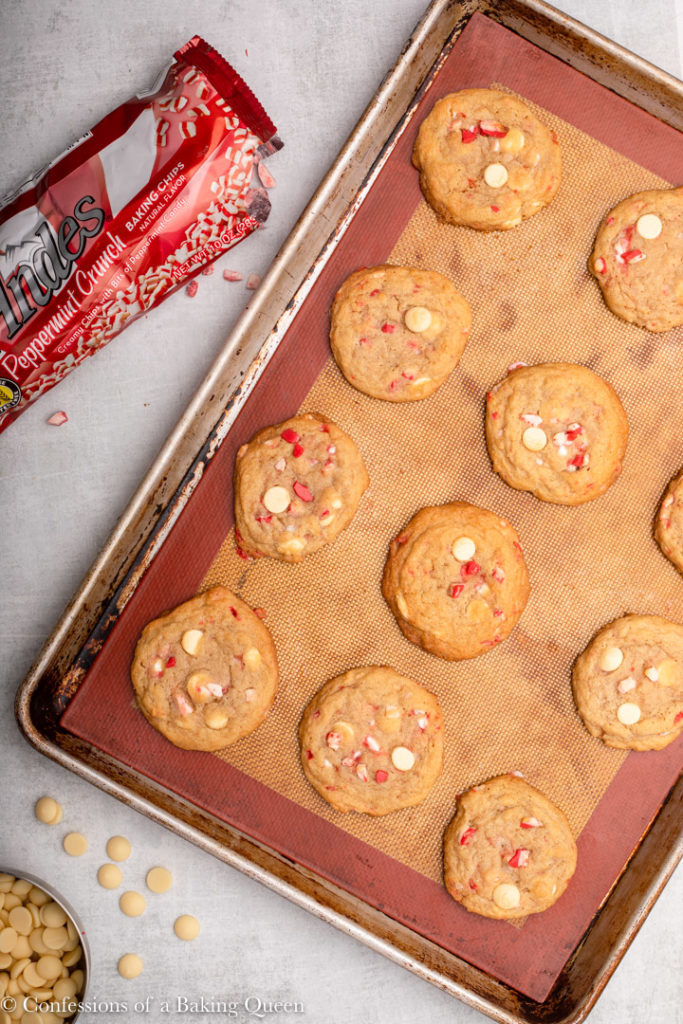 baked White Chocolate Candy Cane Cookies on a silpat lined baking sheet