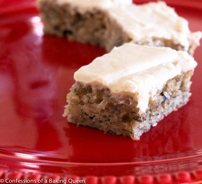 anana bars with cream cheese frosting on a red plate