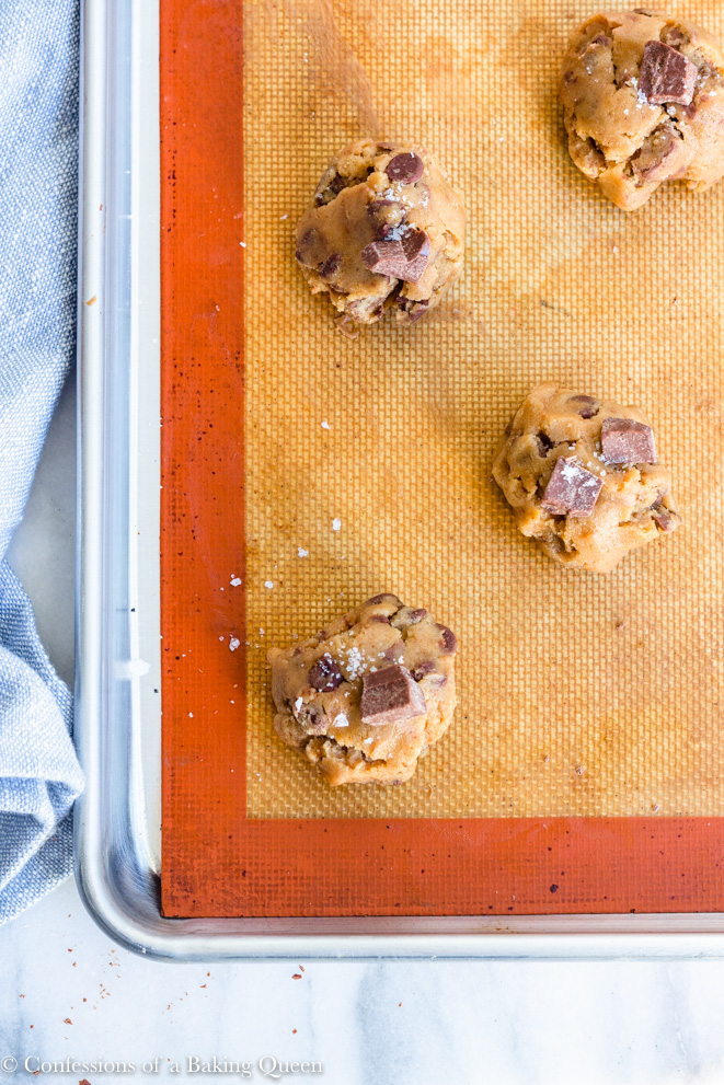 cookie butter sea salt chocolate chip cookie dough on a silpat lined baking sheet