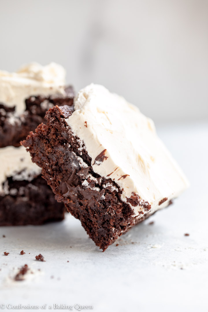 guinness brownie with baileys frosting tilted up on more brownies