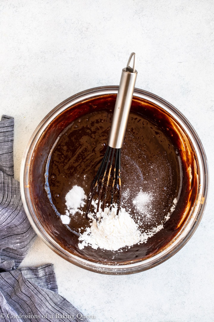 baking soda, salt, and cornstarch added to brownie batter in a glass bowl