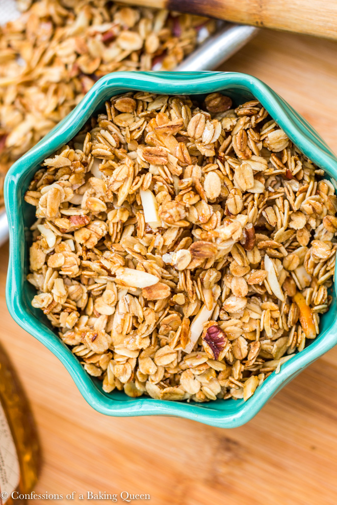 homemade granola recipe in a turquoise bowl on a wood board