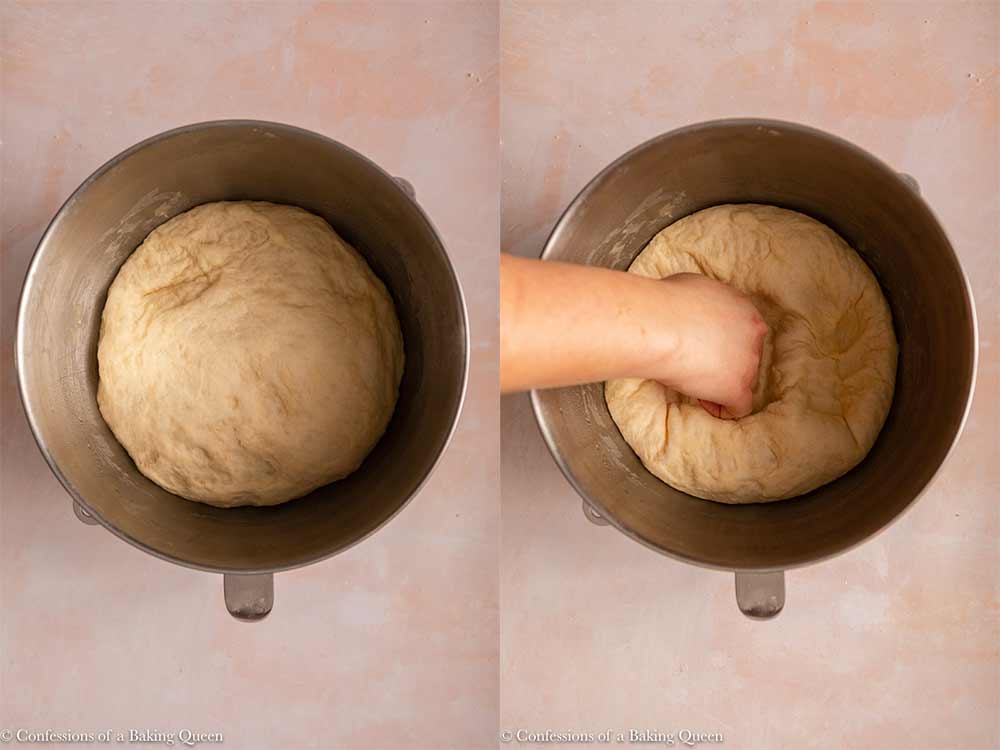 dough risen to double in size then punched down in a metal mixing bowl on a light pink surface