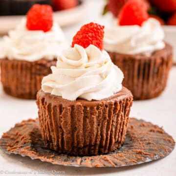 chocolate cheesecake cups lined up on a light surface.