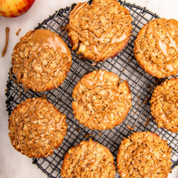 maple glazed apple muffins on a white marble surface