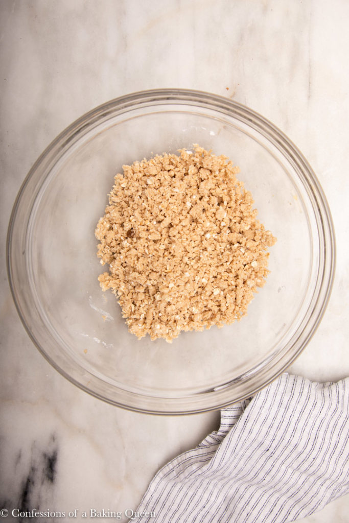 oat streusel in a glass bowl on a marble surface