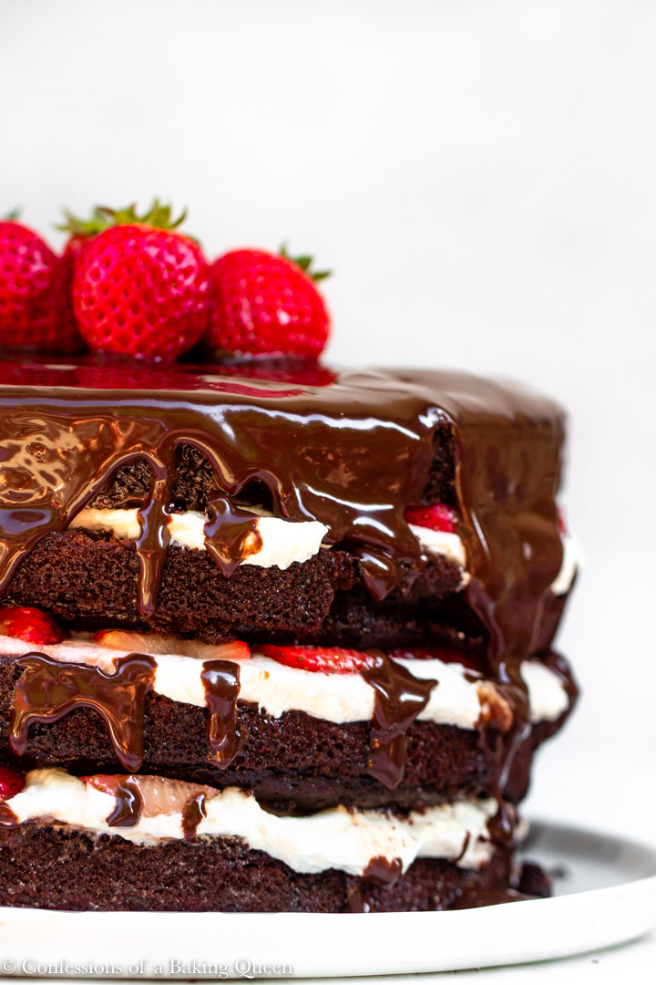 strawberries and cream chocolate cake served on a white plate