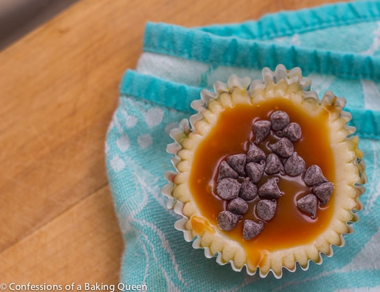 overhead shot of Rolo Cheesecake Cup on a blue tea towel on a wood board