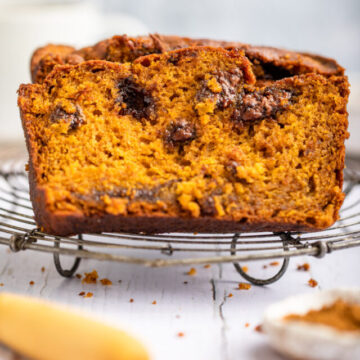 cropped-pumpkin-nutella-bread-slices-on-a-wire-rack-on-a-white-surface-with-a-wooden-knife-and-small-bowl-of-spices-1-of-1.jpg