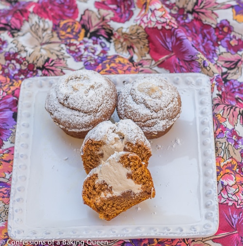 Maple Cream Filled Pumpkin Muffins on a white plate on a pink and purple floral linen