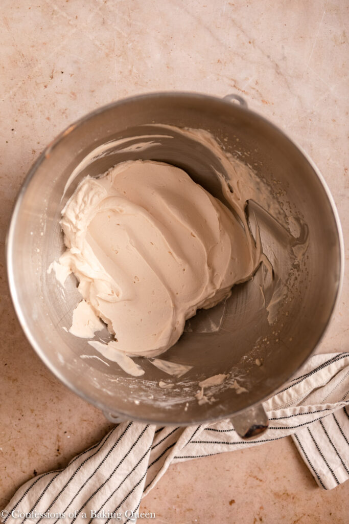 dorda chocolate whipped cream in a metal bowl on a light brown surface