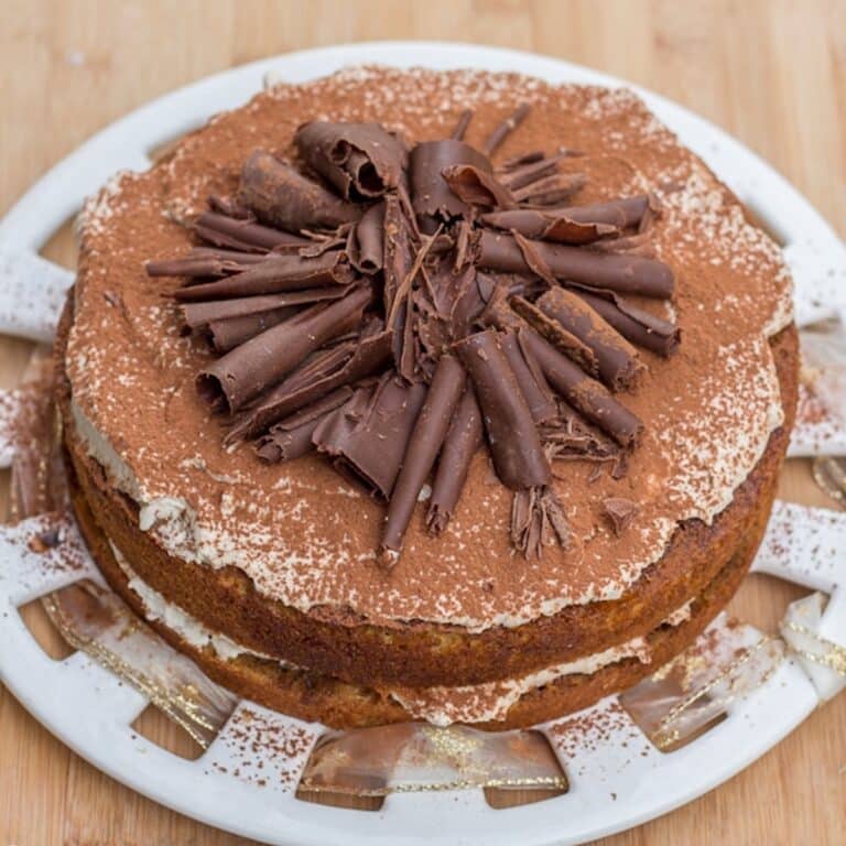 Tiramisu Cake on a white plate with a wood background