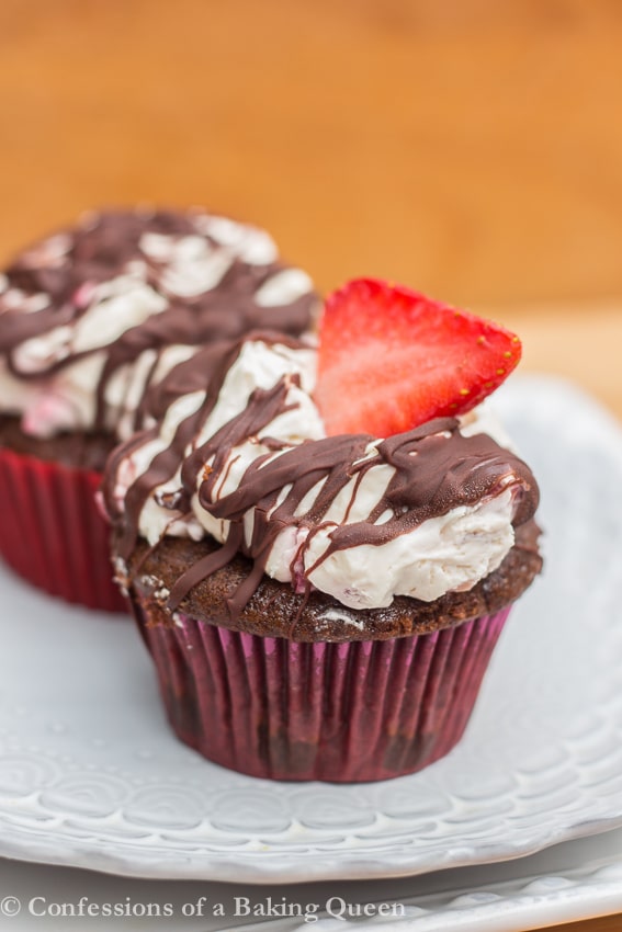 Strawberry Chocolate Cupcakes on a purple and white plate on a wood background