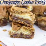 Cookie Butter Chocolate Chip Cheesecake Bars stacked on top of each other on a white plate on a white wooden background