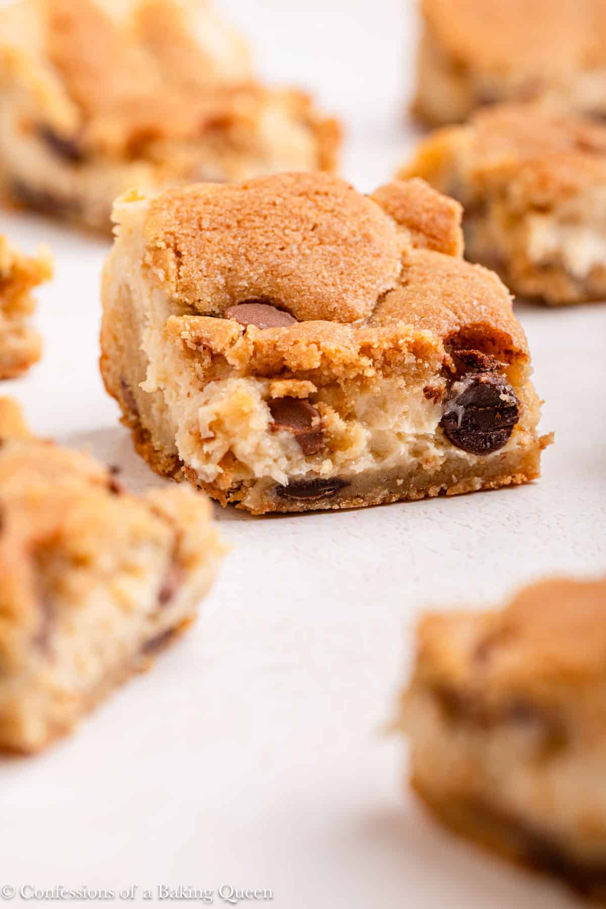cheesecake cookie bars on a light surface.