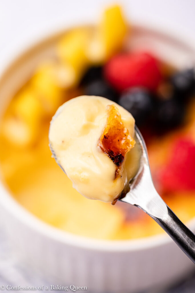 spoonful of lemon creme brulee held up to the camera