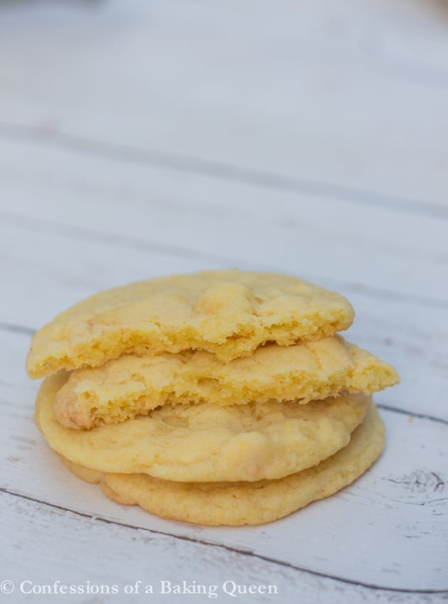 Chewy Lemon Cookies stacked on a white background