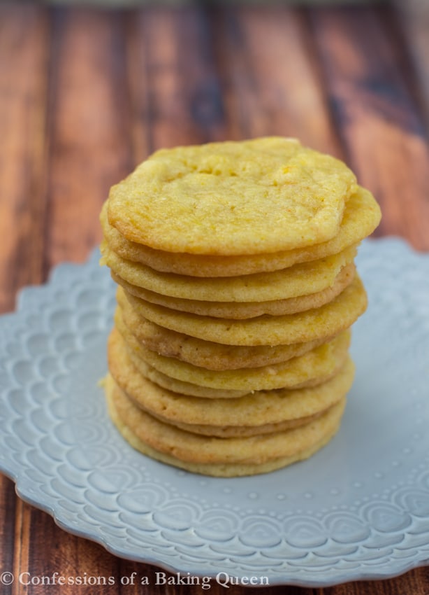 Chewy Lemon Cookies stacked on a purple plate on a wood background