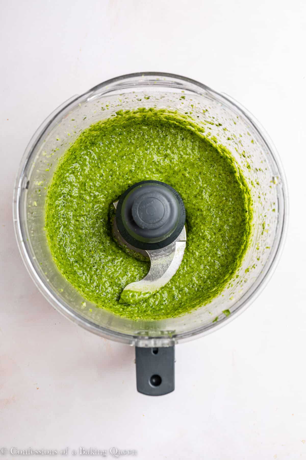 basil pesto made in a food processor on a light surface