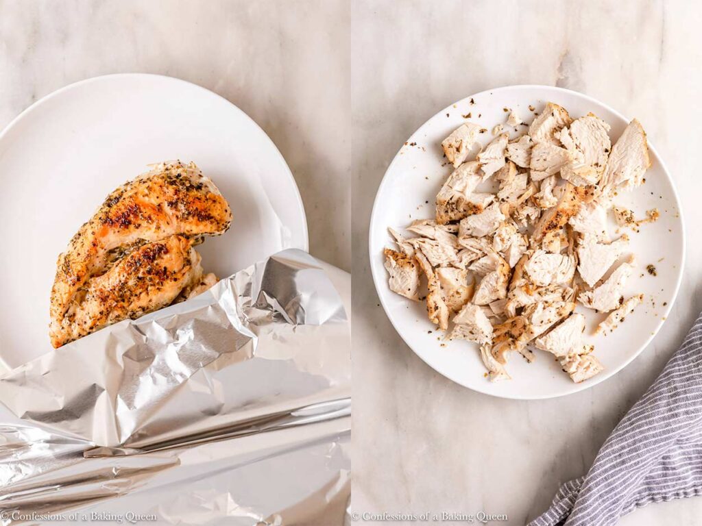 chicken breast rested then chopped up into bite size pieces on a white plate on a marble surface
