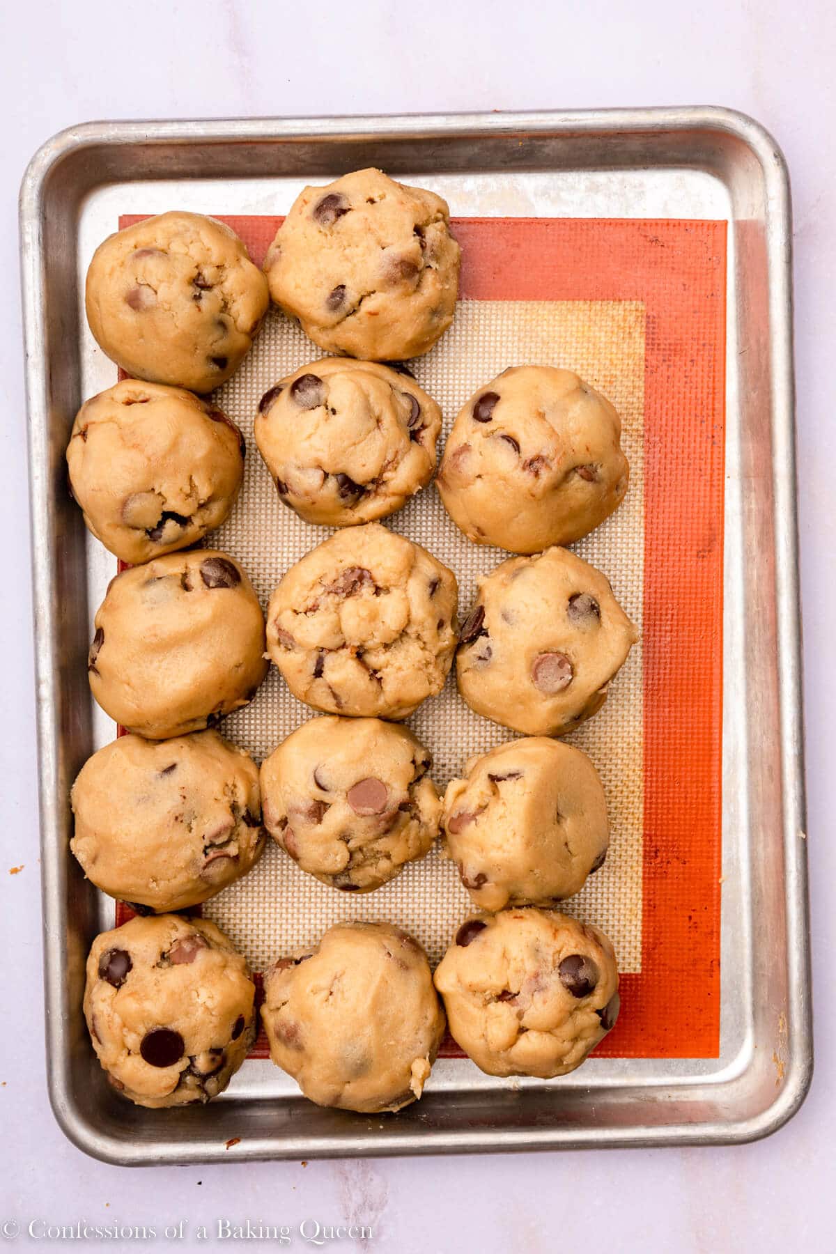 nutella chocolate chip cookie dough balls on an silpat lined baking sheet