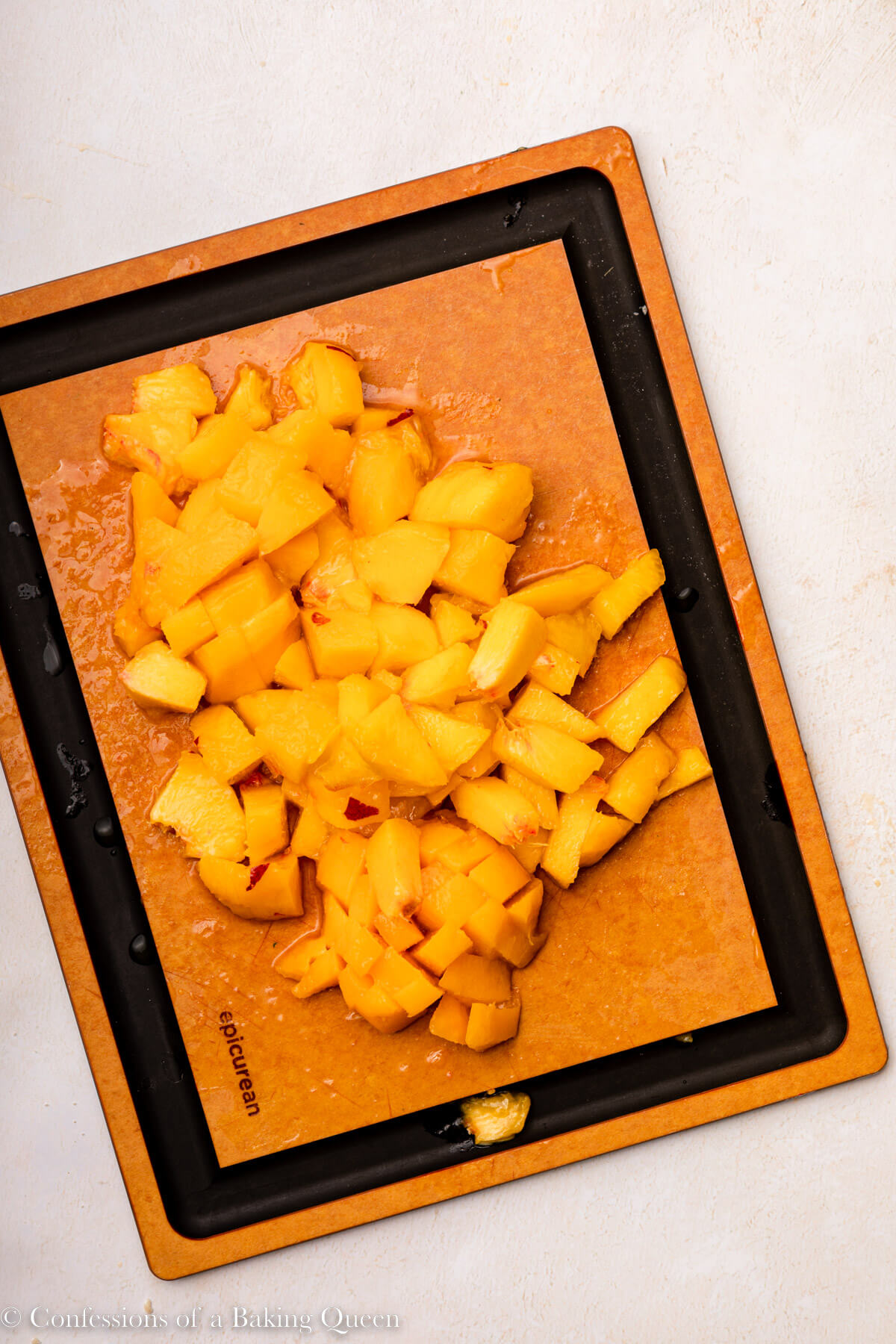 peaches cut up on a cutting board on a light surface
