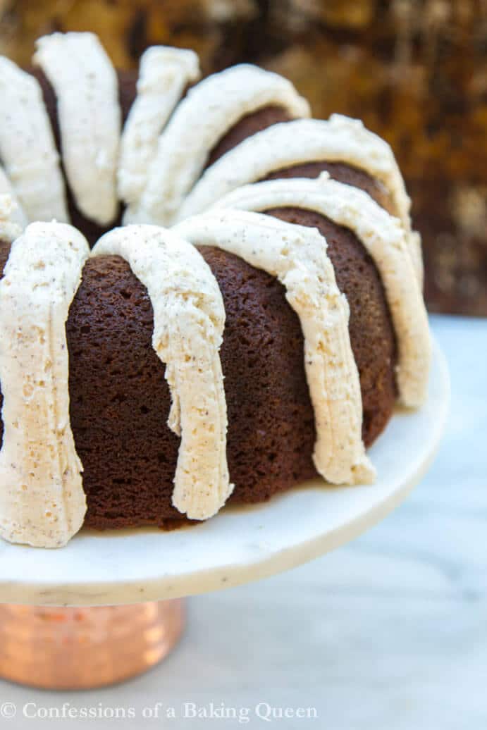 Guinness Gingerbread Cake served in a white cake plate on a white and brown background
