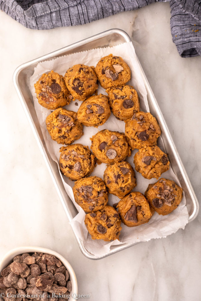 balls of pumpkin chocolate chunk cookies on a small metal tray