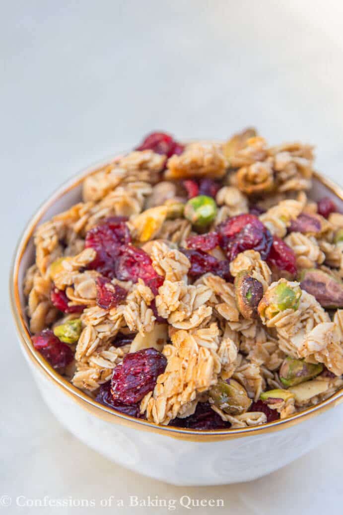 Christmas Granola in a gold lined cream bowl on a light grey background