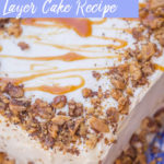 carrot cake layer cake with crushed nuts and salted caramel drizzle served on a blue serving plate