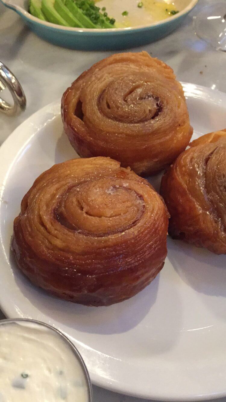 cinnamon swirl buns on a white plate from Sadelles in new york