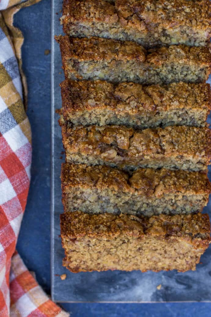 Oat Flour Skinny Banana Bread on a dark surface next to an orange and white checkered linen