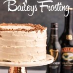 cake on a cake stand next to a bottle of Guinness and a bottle of Baileys