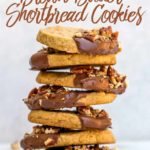 stack of chocolate dipped brown butter shortbread cookies on a white surface