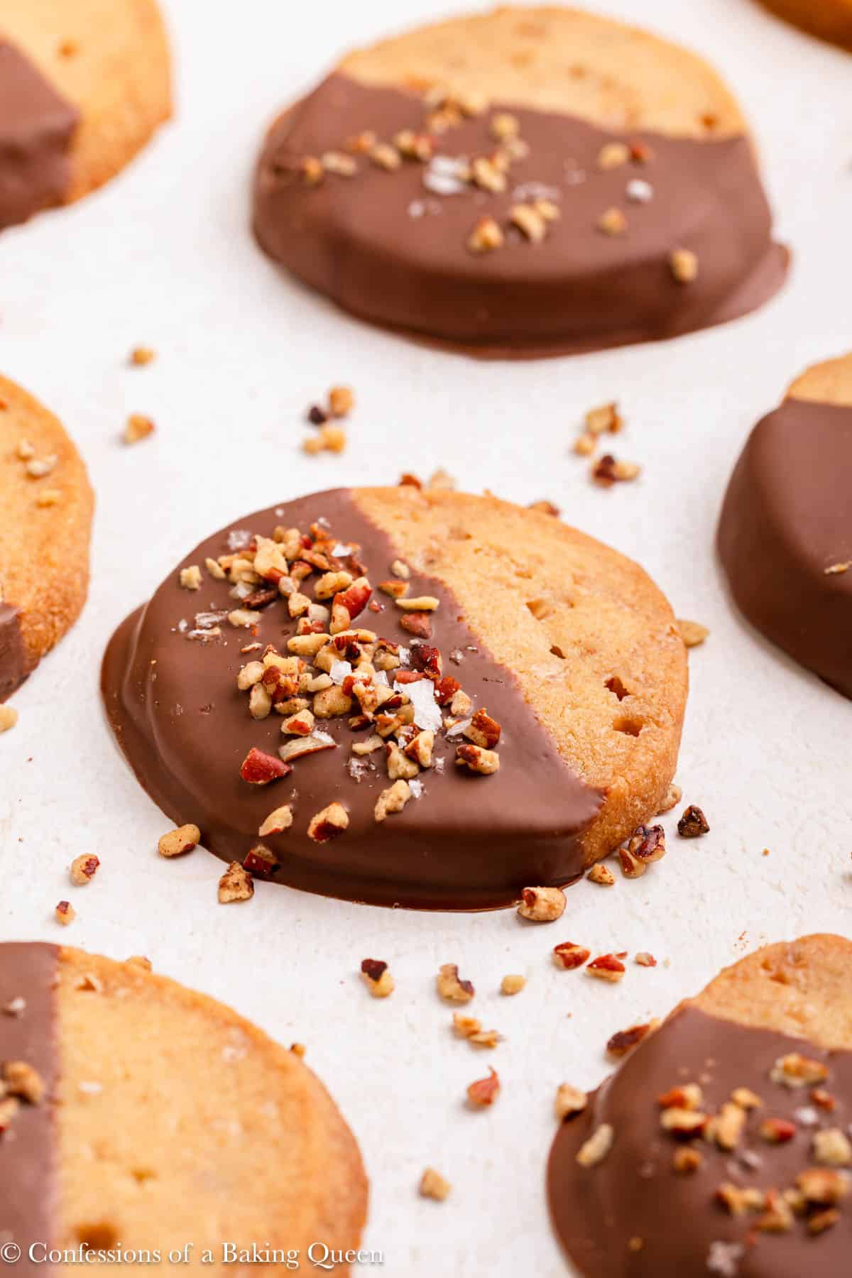 chocolate dipped toffee cookies on a light surface