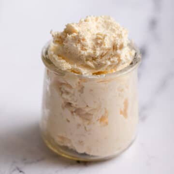 glass jar of clotted cream on a marble surface