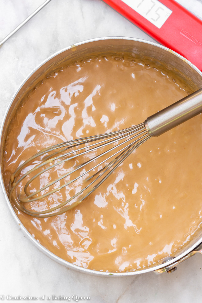 carmel sauce cooked in a saucepan with a wire whisk in
