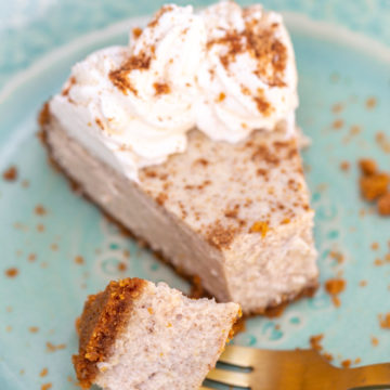 a gold fork taking a bite out of a chai cheesecake slice