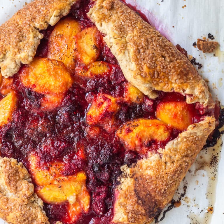 just baked Peach Raspberry Galette Recipe cooling on parchment paper