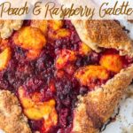 peach raspberry galette baked on a piece of parchment paper