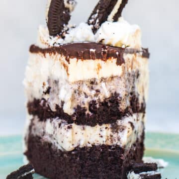 cookies and cream ice cream cake slice on a turquoise plate