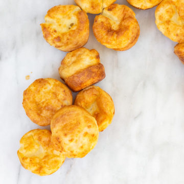 Yorkshire puddings in a snack like position on a white marble surface