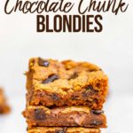a stack of chewy chocolate chunk pumpkin blondies on a white marble surface