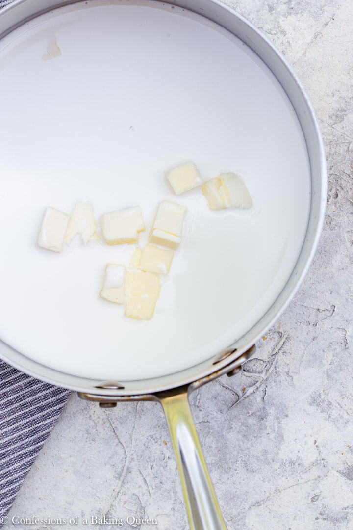 butter cubes in milk in a large metal pot for a french toast recipe