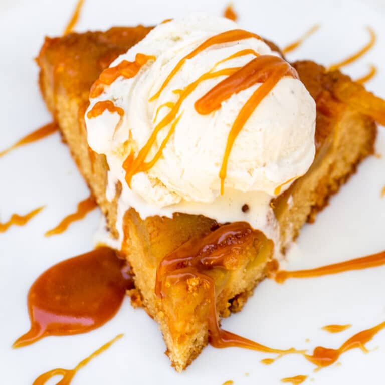 upside down caramel apple cake served with a scoop of vanilla ice cream and drizzles of salted caramel