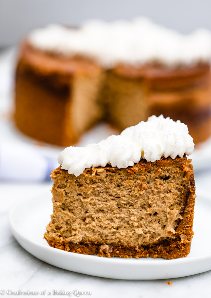 up close of a slice of whipped cream topped gingerbread cheesecake